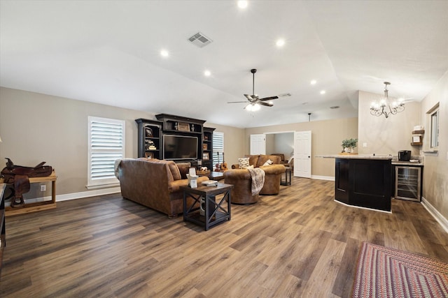 living room with hardwood / wood-style flooring, beverage cooler, vaulted ceiling, and a healthy amount of sunlight