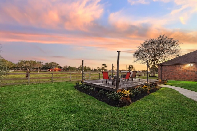 yard at dusk with a wooden deck