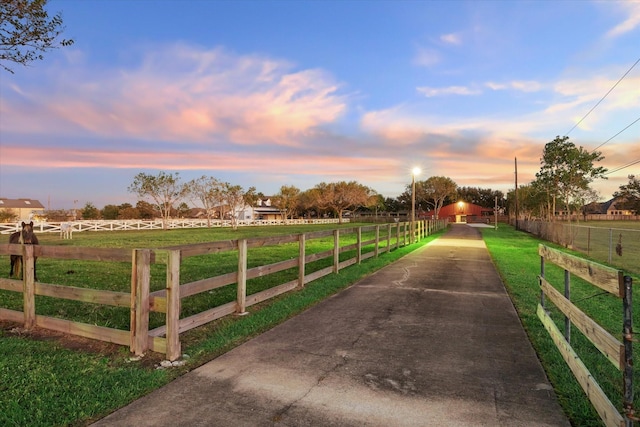 yard at dusk with a rural view