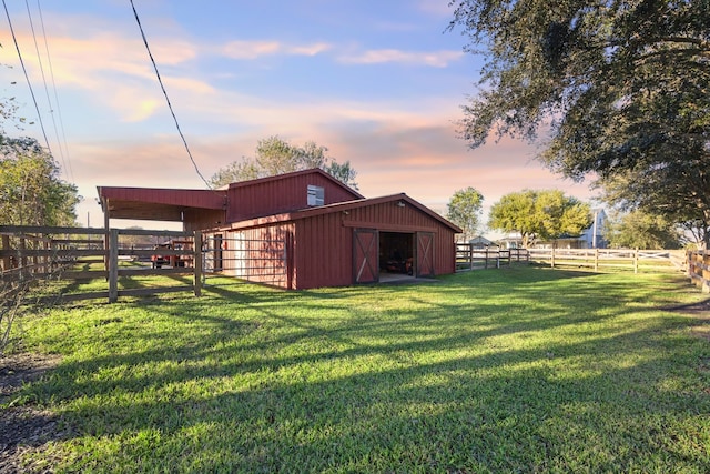 outdoor structure at dusk featuring a rural view