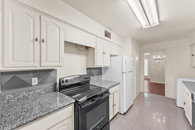 kitchen with white cabinets, washer / clothes dryer, light tile patterned flooring, and black range with electric stovetop