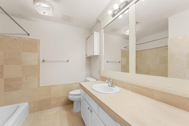 full bathroom featuring toilet, shower / washtub combination, vanity, and tile walls