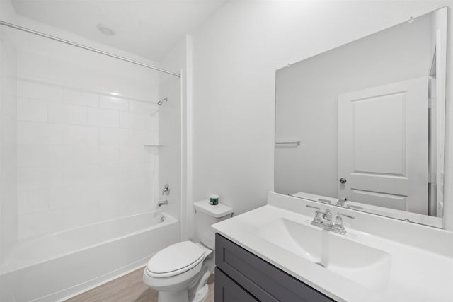 full bathroom with wood-type flooring, toilet, vanity, and  shower combination