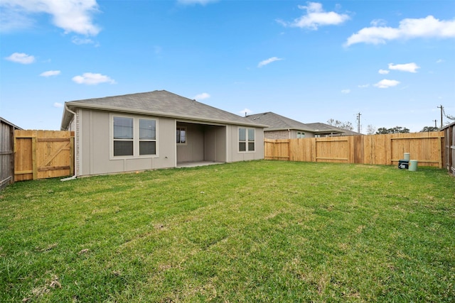 rear view of property with a patio area and a yard