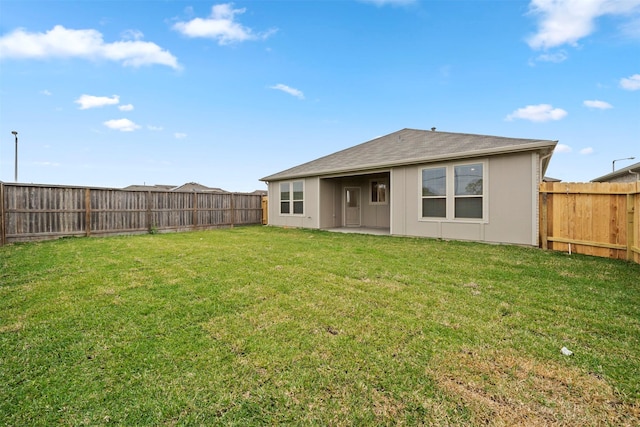 rear view of house with a yard