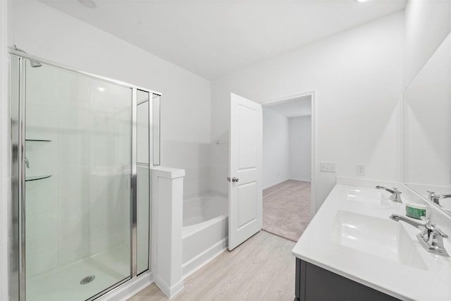 bathroom with vanity, hardwood / wood-style floors, and shower with separate bathtub