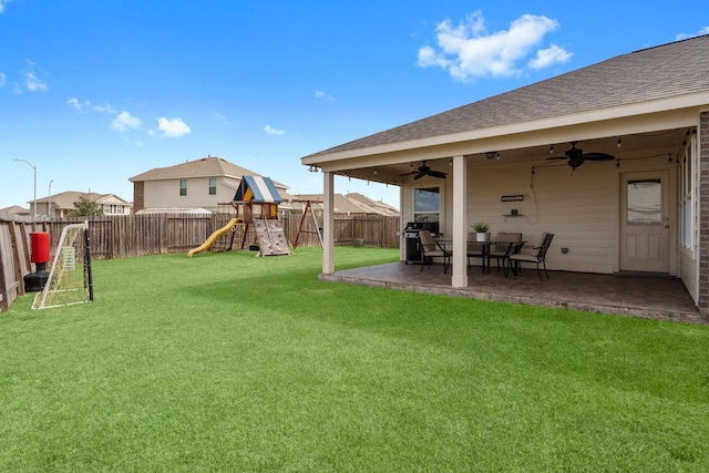 view of yard featuring a patio area, a playground, and ceiling fan