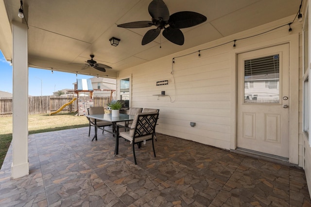 view of patio with a playground and ceiling fan