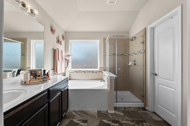 bathroom with separate shower and tub, vaulted ceiling, and vanity