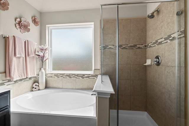 bathroom with vanity, a wealth of natural light, and independent shower and bath