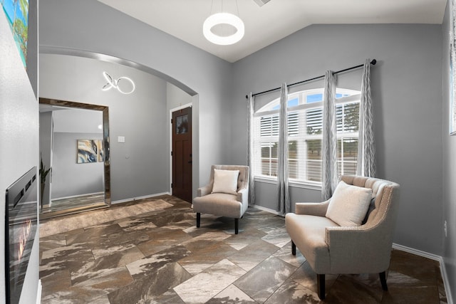 sitting room featuring vaulted ceiling