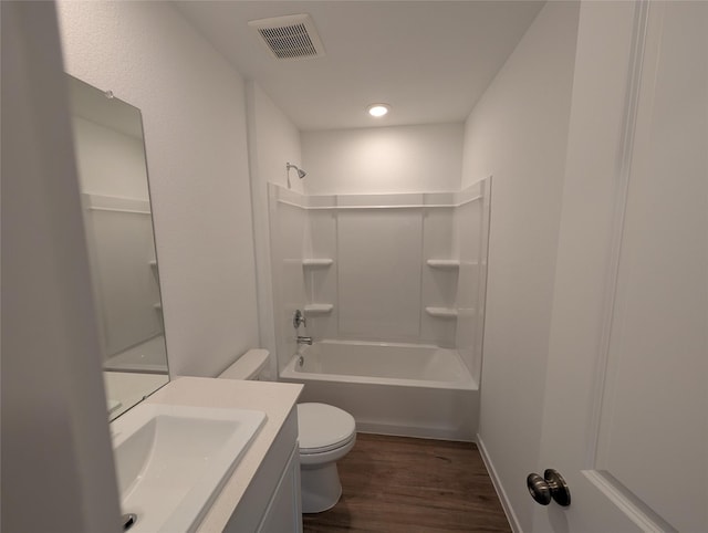 full bathroom featuring toilet, hardwood / wood-style flooring, shower / tub combination, and vanity