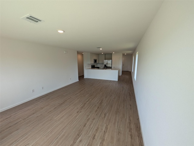 unfurnished living room with hardwood / wood-style floors