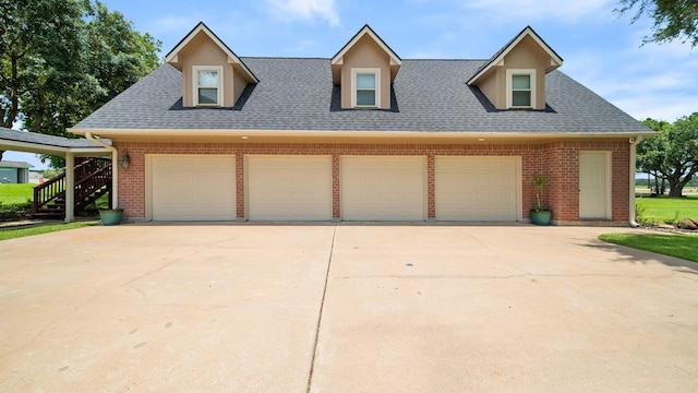 cape cod home with a garage