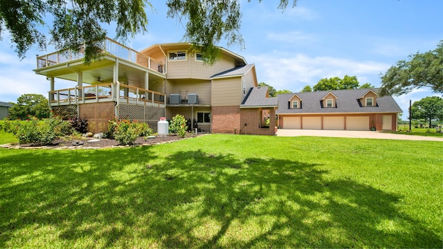 view of front facade featuring ceiling fan, a garage, a front lawn, and a balcony