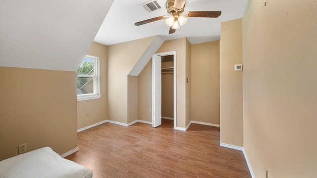 bonus room featuring lofted ceiling, light hardwood / wood-style floors, and ceiling fan