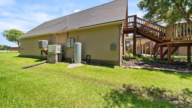 back of house with a deck, a yard, and central AC unit