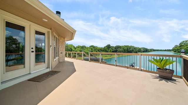 view of patio featuring french doors and a water view