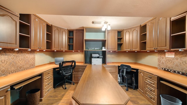 office area featuring built in desk and light hardwood / wood-style flooring