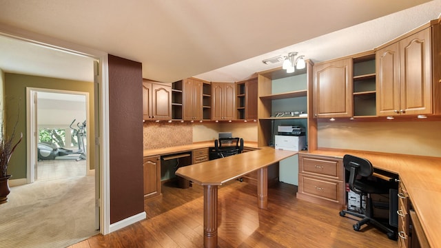 office area featuring dark hardwood / wood-style floors and built in desk