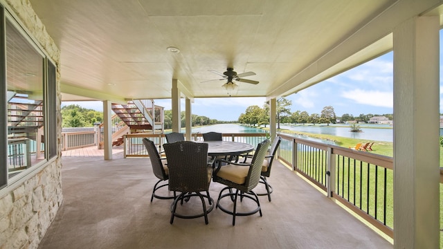 view of patio featuring a water view and ceiling fan