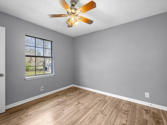 spare room featuring a textured ceiling, ceiling fan, and light hardwood / wood-style flooring