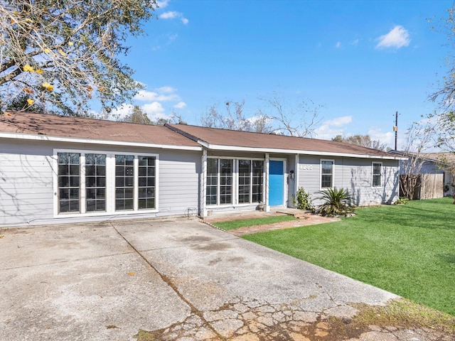 back of house featuring a yard and a patio area