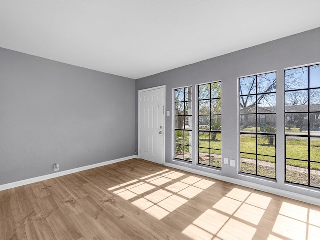 unfurnished room with hardwood / wood-style flooring