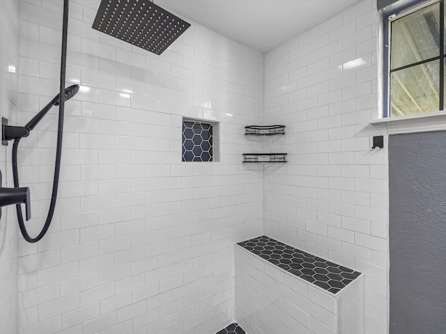 bathroom with a tile shower