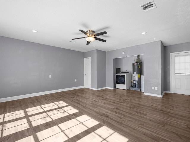 unfurnished living room with water heater, washer / dryer, ceiling fan, and wood-type flooring