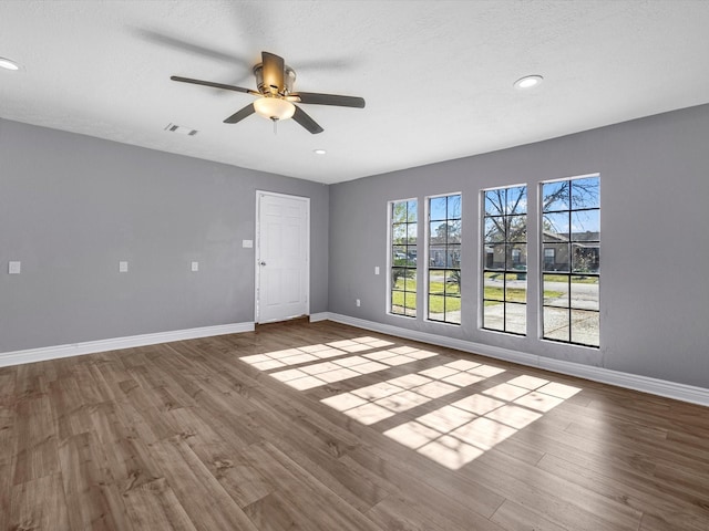 unfurnished room featuring ceiling fan and hardwood / wood-style flooring