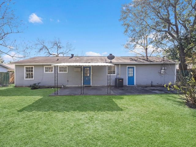 back of property with a lawn, central AC unit, and a patio