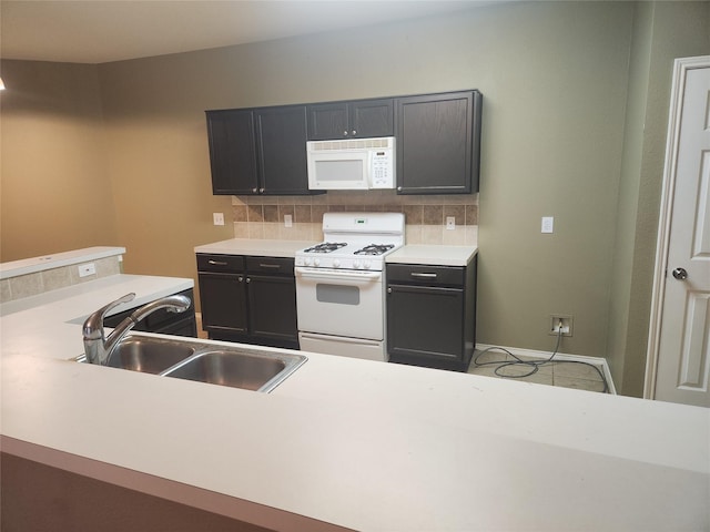 kitchen featuring tasteful backsplash, sink, tile patterned flooring, and white appliances