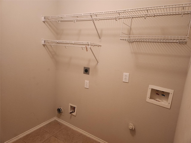 laundry room featuring gas dryer hookup, washer hookup, tile patterned flooring, and electric dryer hookup