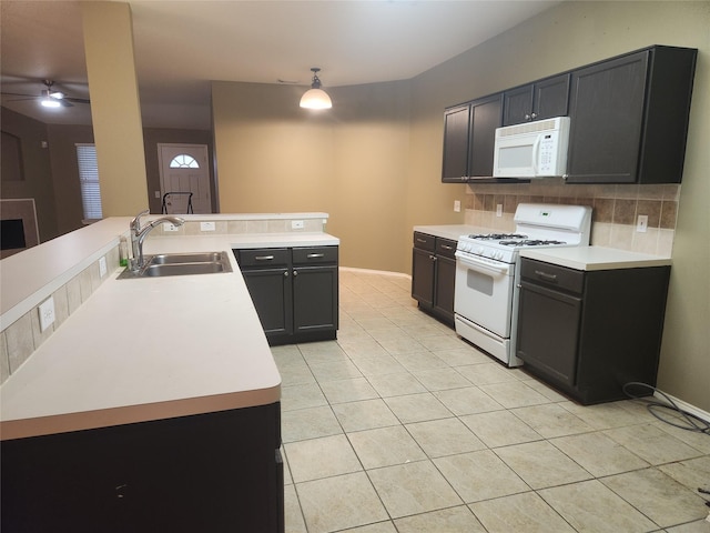 kitchen with sink, light tile patterned floors, ceiling fan, white appliances, and backsplash