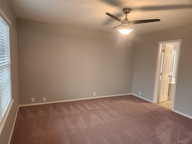 carpeted spare room with ceiling fan