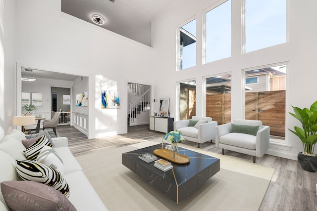 living room featuring a high ceiling, hardwood / wood-style floors, and a wealth of natural light