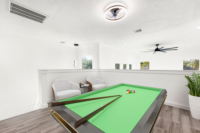 recreation room featuring ceiling fan, hardwood / wood-style floors, billiards, and a textured ceiling