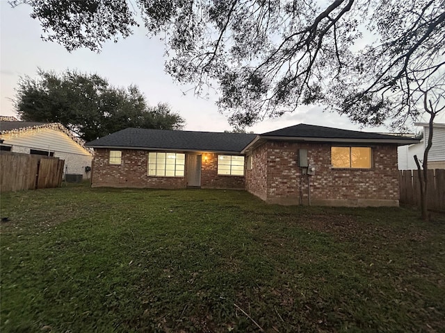 rear view of house featuring a lawn