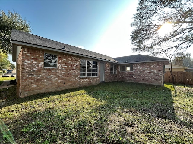 back of house with a lawn