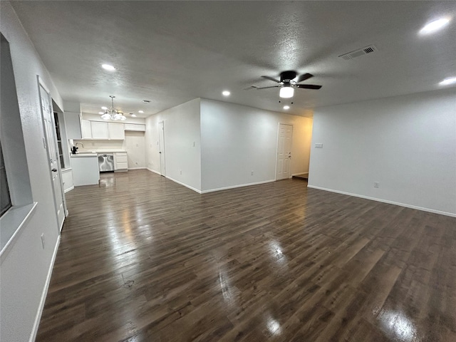 unfurnished living room with sink, dark hardwood / wood-style floors, ceiling fan with notable chandelier, and a textured ceiling