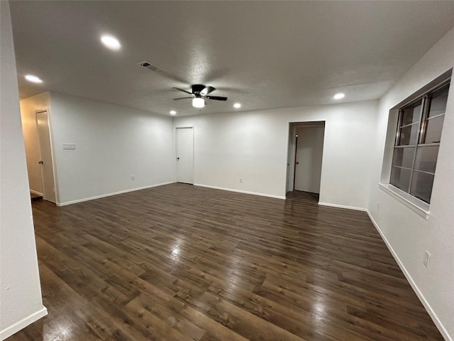 empty room with ceiling fan and dark hardwood / wood-style floors