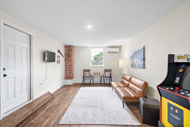 living area with wood-type flooring and a wall mounted AC