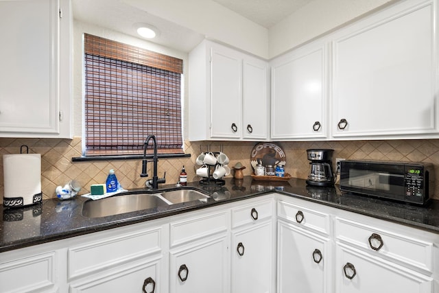 kitchen featuring sink, white cabinetry, and tasteful backsplash