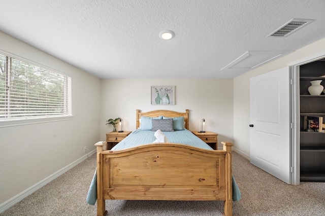 bedroom featuring a textured ceiling and carpet