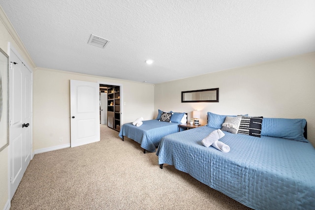 bedroom with a textured ceiling, light carpet, and crown molding