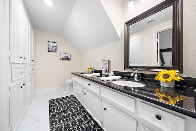 bathroom with a textured ceiling, lofted ceiling, vanity, and toilet