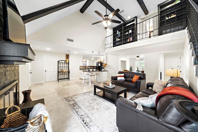 living room featuring ceiling fan, high vaulted ceiling, beamed ceiling, and a fireplace