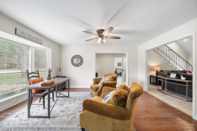 office space featuring a textured ceiling, ceiling fan, and hardwood / wood-style flooring