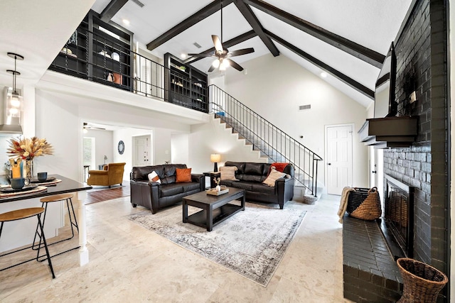 living room featuring ceiling fan, high vaulted ceiling, beamed ceiling, and a fireplace